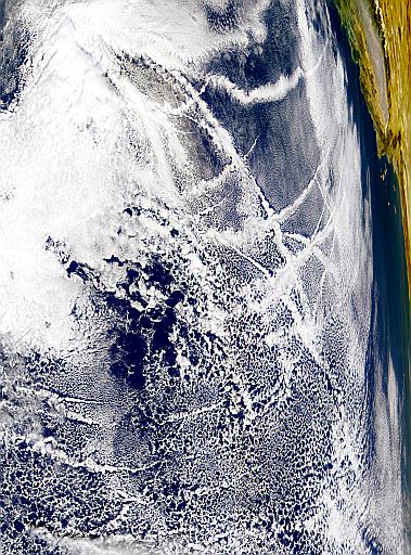 These odd cloud formation over the Pacific Ocean southwest of California possibly started out as a collection of airplane contrails.